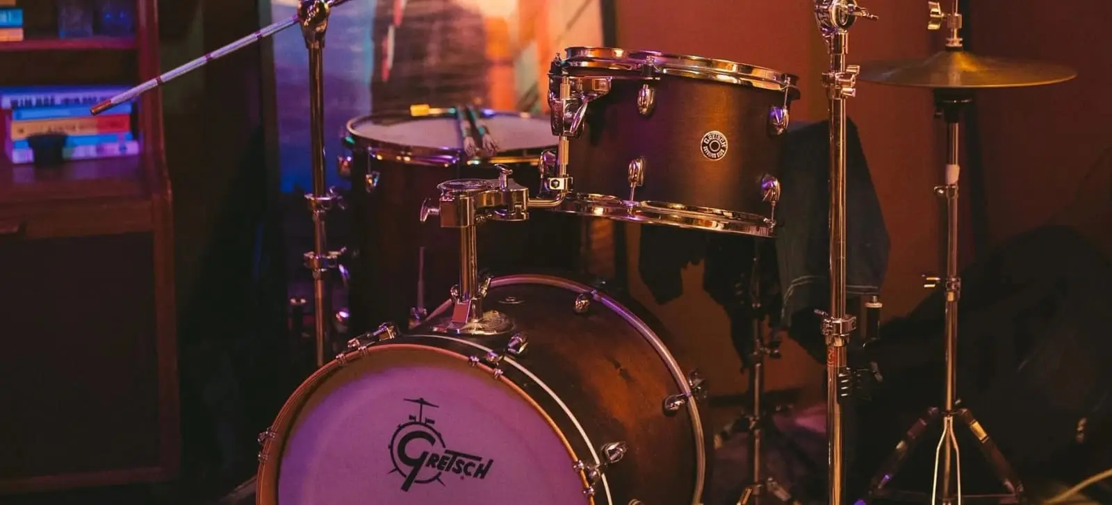 A Gretsch drum kit set up on the basement stage