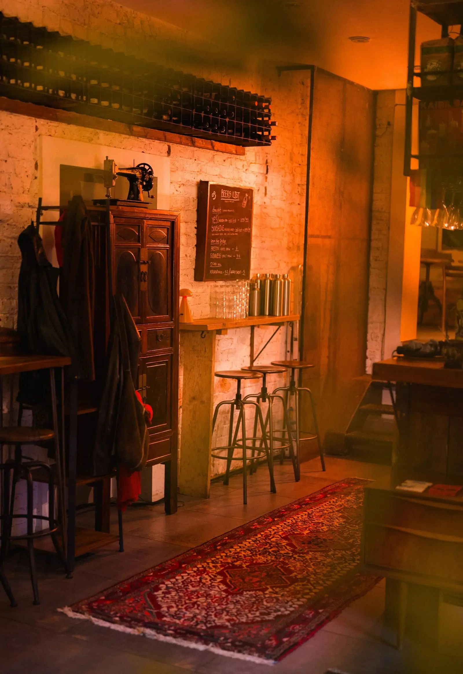 The shop floor: whitewashed brick, a chalkboard beer list and stools along the bar